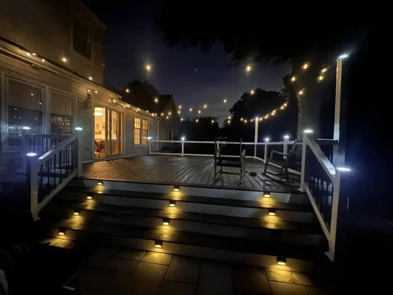 Composite deck with post lights and string lights at night