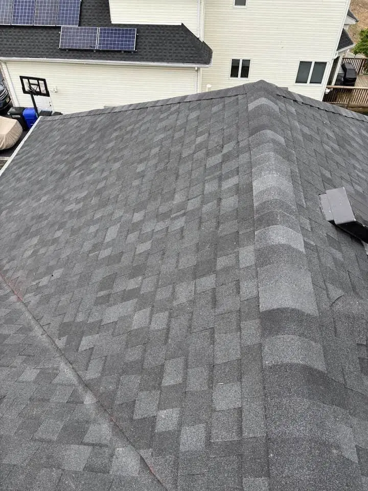 New gray architectural shingle roof with straight hip lines