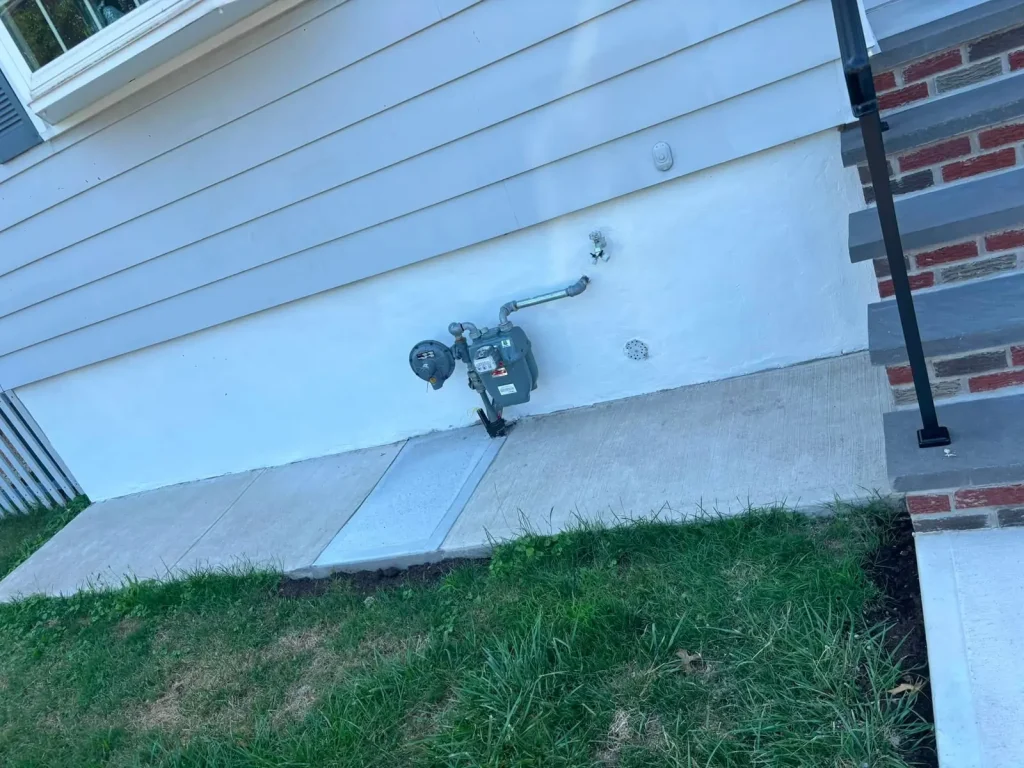 New poured concrete slab along the side of a house
