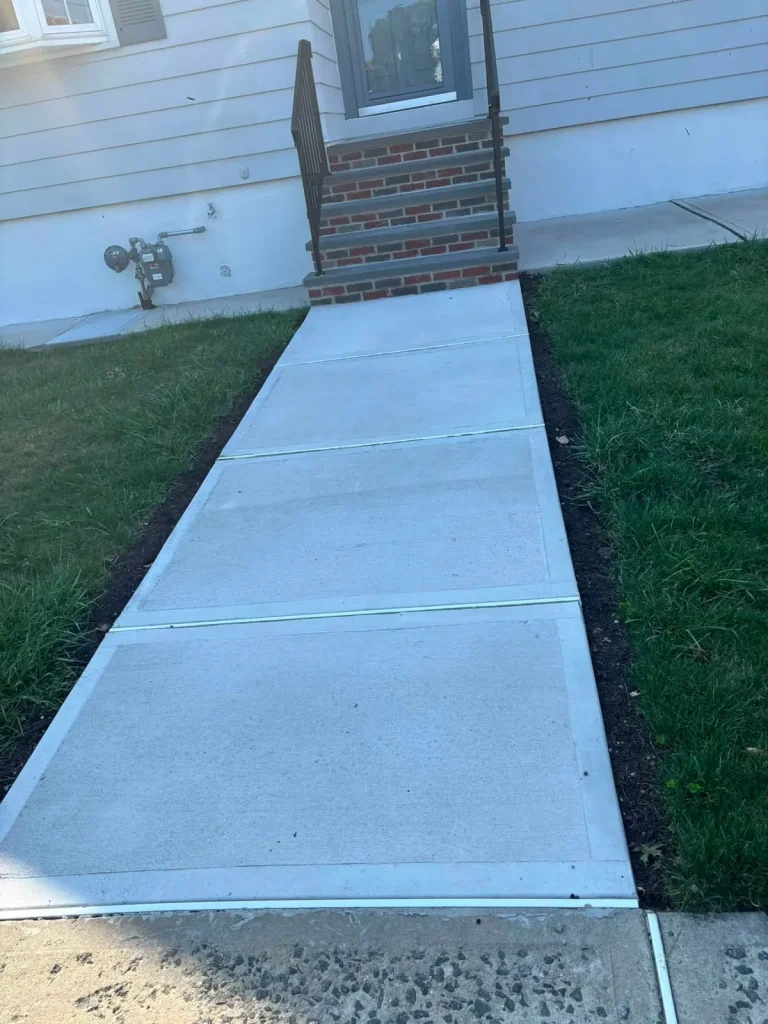 New poured concrete walkway leading to brick front steps