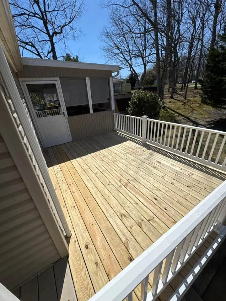 New pressure-treated deck with white vinyl railings