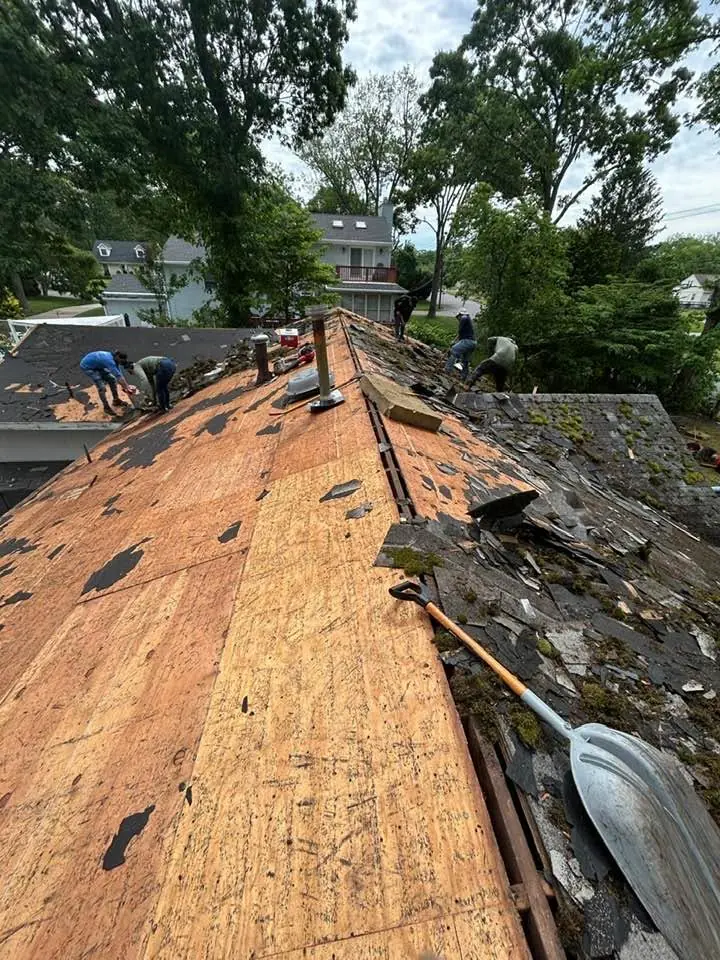 Old shingles stripped down to the roof boards during a tear-off